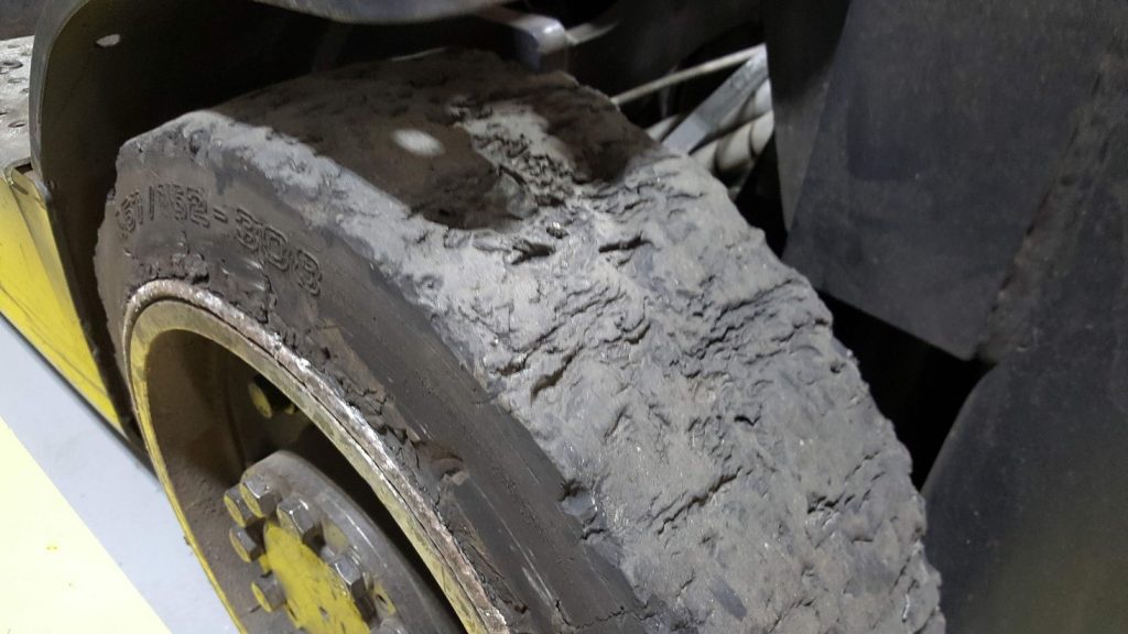 An example of a broken tire. Large amounts of missing rubber along with chunking (large chunks of missing rubber) of the rubber in the middle. This tire will make your forklift a very bumpy ride and may cause a potential accident. Damage like this is caused by riding over worn ramps or sharp metal protrusions.